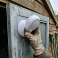 Magnetic LED motion sensor light placed on a shed door frame