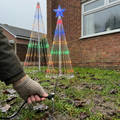 6.5ft outdoor LED Christmas tree lightshow on a front lawn