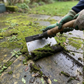 Garden cleaning shovel scraping moss from a patio