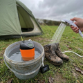 Portable camping shower in use at a campsite