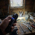 Rechargeable LED torch lighting a shed workbench