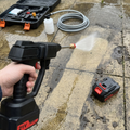 Cordless pressure washer cleaning a patio