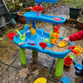 Kids sand and water table set up on a garden patio